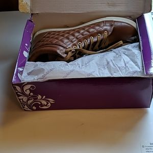 Pair of forever quilted zip and tie boot type shoe